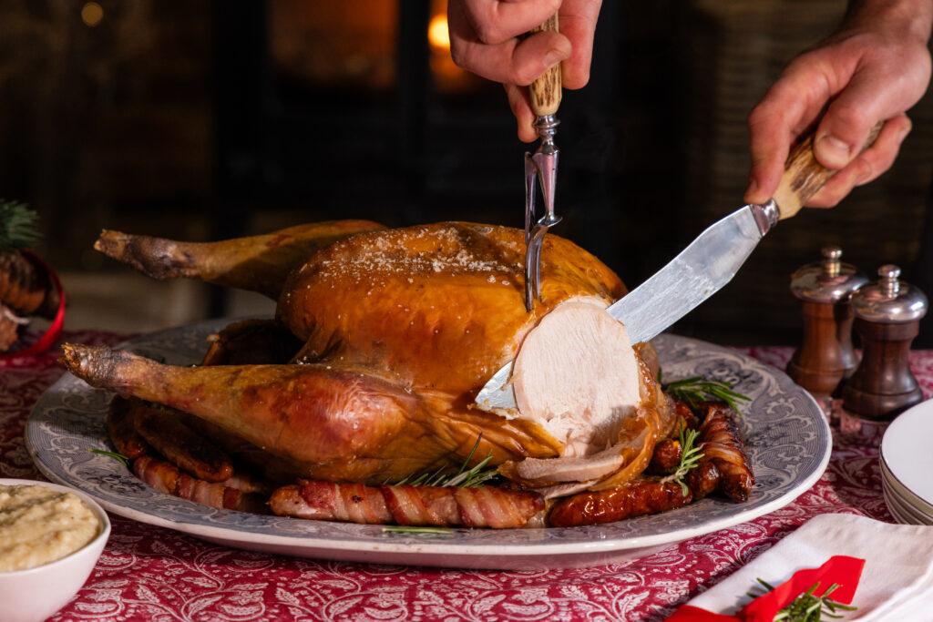 Organic Bronze turkey being carved